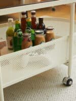 Tempered Glass Oval Coffee Table with Vented Metal Storage and Swivel Wheels - Brown and White - Image 9